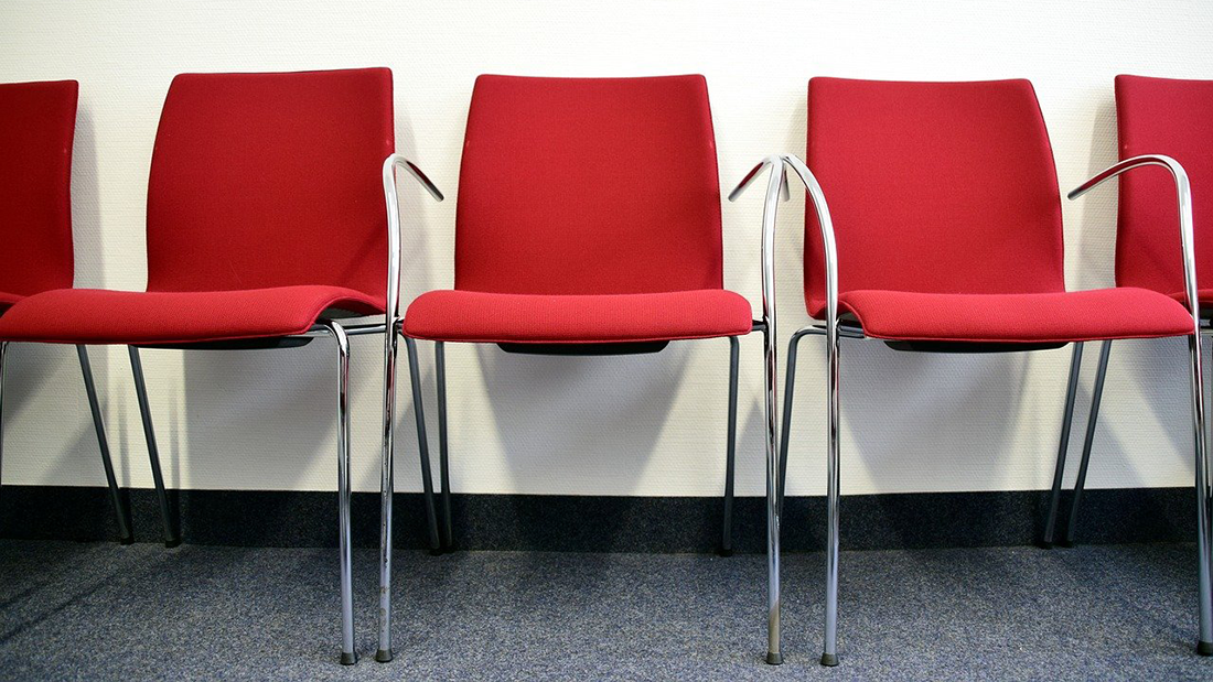 Red chairs in a waiting area.