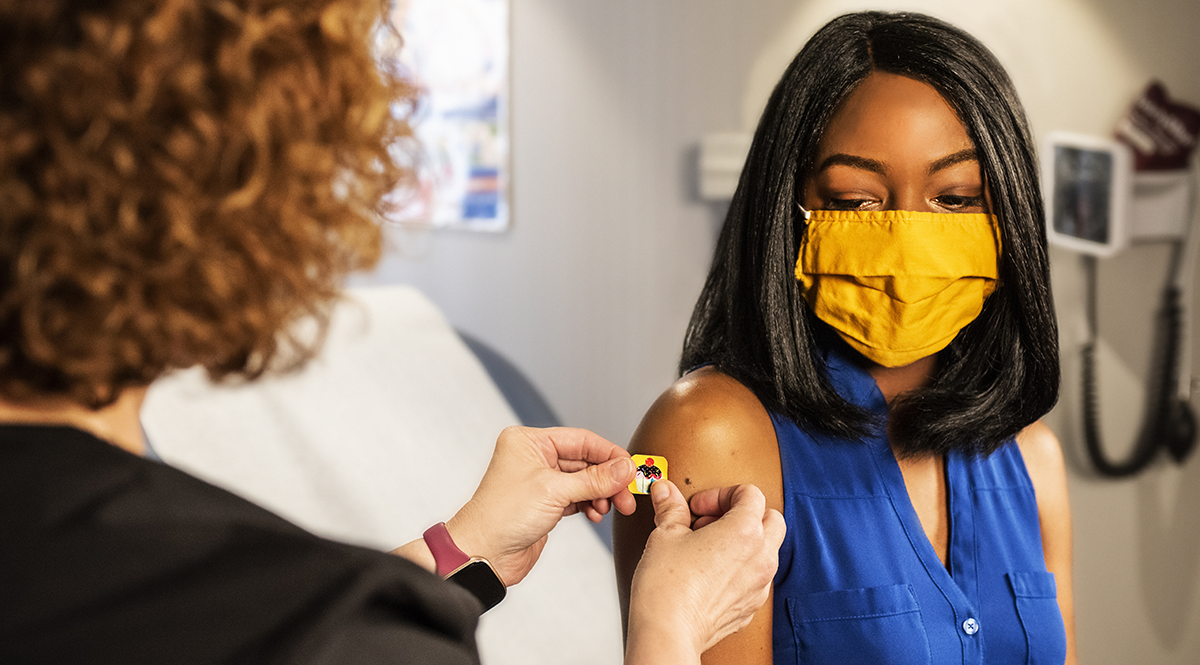 A woman receives a vaccine.