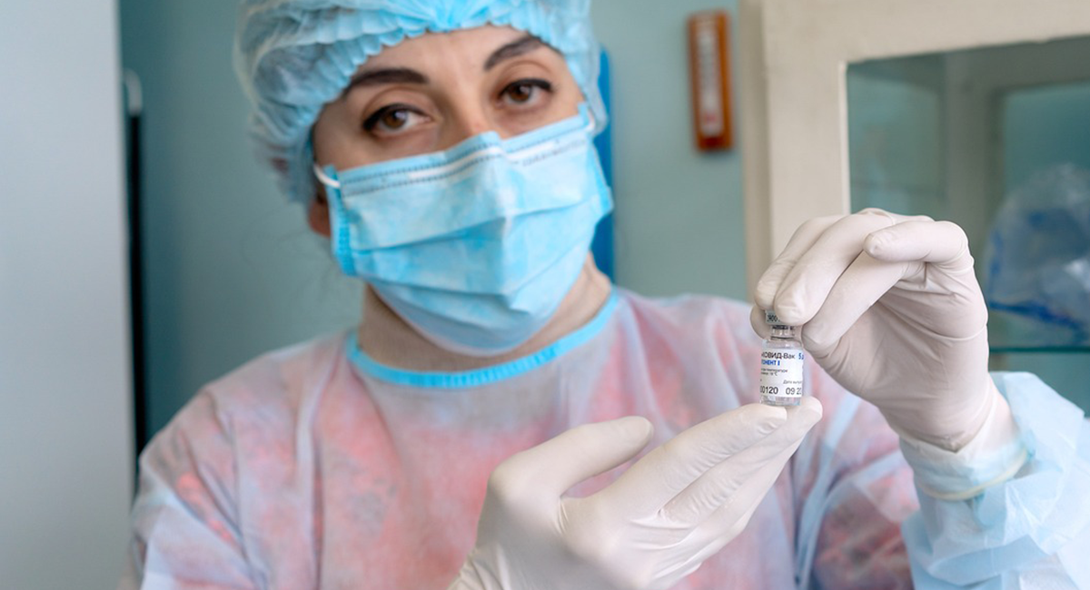 A nurse holding a vial of COVID-19 vaccine.