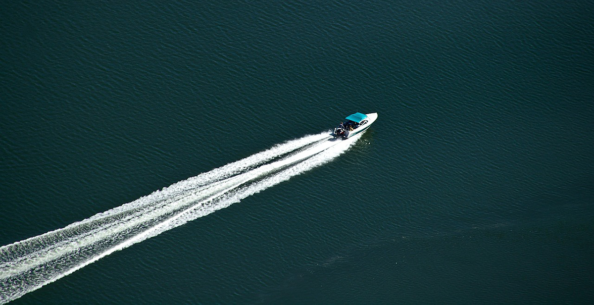 A speedboat with a wake behind it