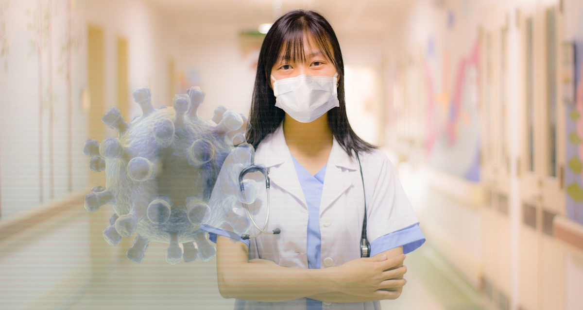A healthcare professional stands in a clinic hallway, surrounded by pandemic graphics.