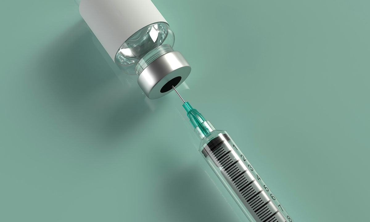 Syringe and a vaccine vial.